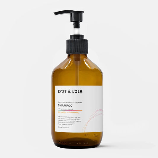 Dot & Lola plant-based repair shampoo with bergamot, geranium, and orange peel in amber bottle with pump
